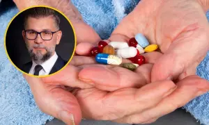 Mężczyzna w okularach i garniturze obok dłoni starszej osoby z garścią tabletek. Czy suplementy diety działają?